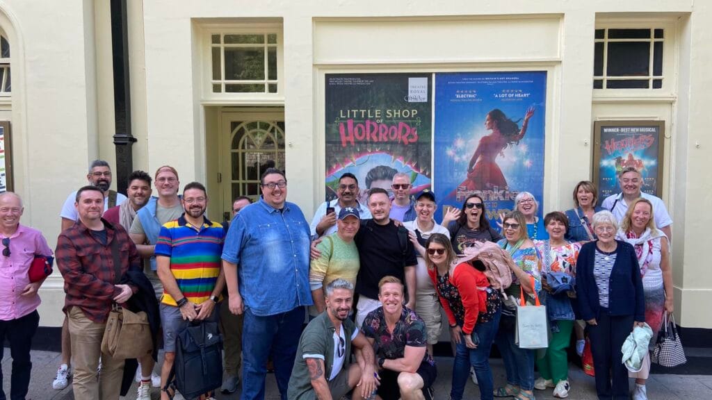 West End Outings members posing outside a London theatre before an afternoon matinee