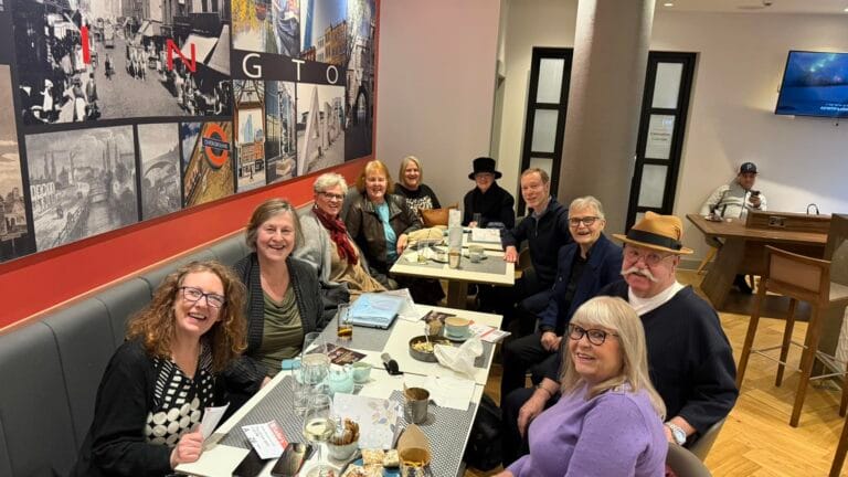 West End Outings members at a pre-show meal in a London-themed restaurant before a matinee