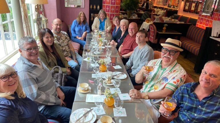 Matinee Club members sharing a long lunch table ahead of a daytime West End show