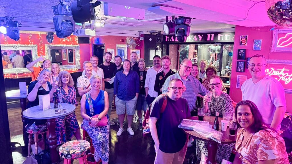Members of a London theatre social group socialising before the curtain