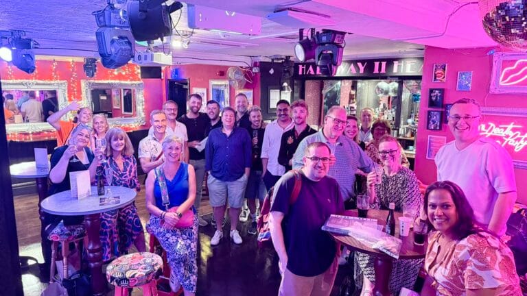 Members of a London theatre social group socialising before the curtain